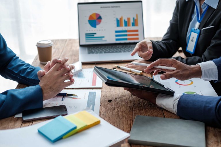 Business team analyzing income charts and graphs with modern laptop computer. Close up.Business analysis and strategy concept
